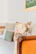 A serene corner with comfortable chairs and pastel pink cushions, perfect for family sessions.