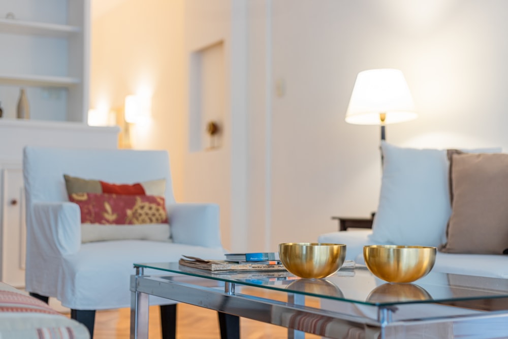 a living room filled with furniture and a glass table