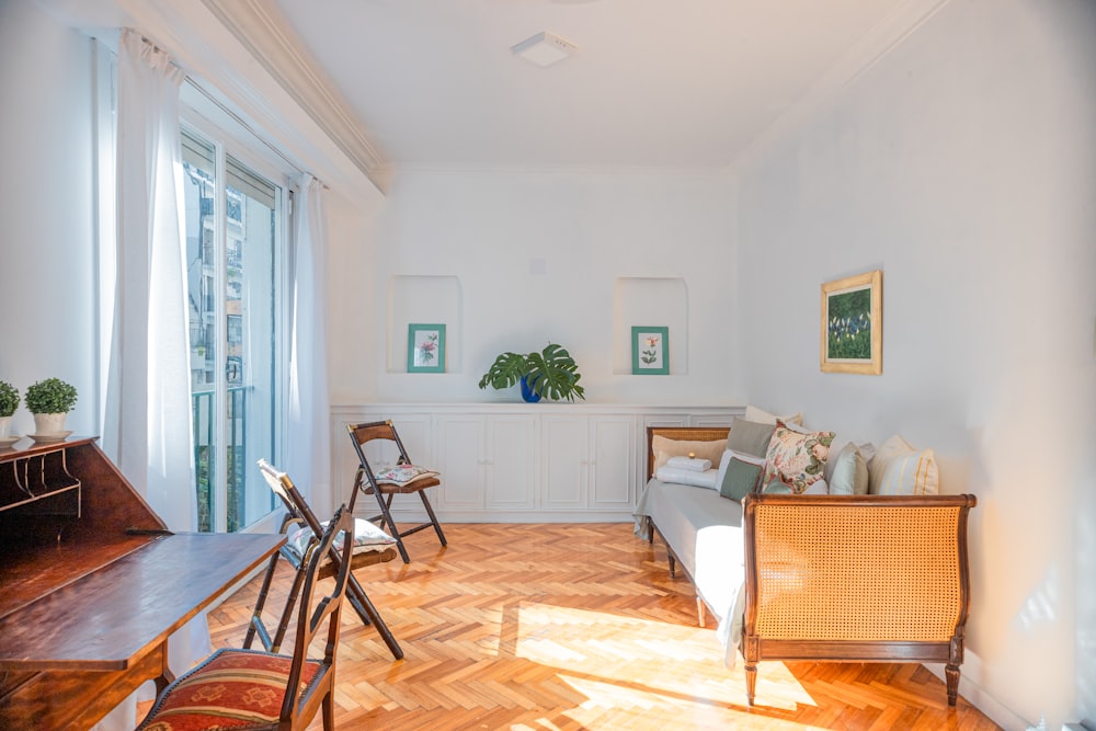 a living room filled with furniture and a large window