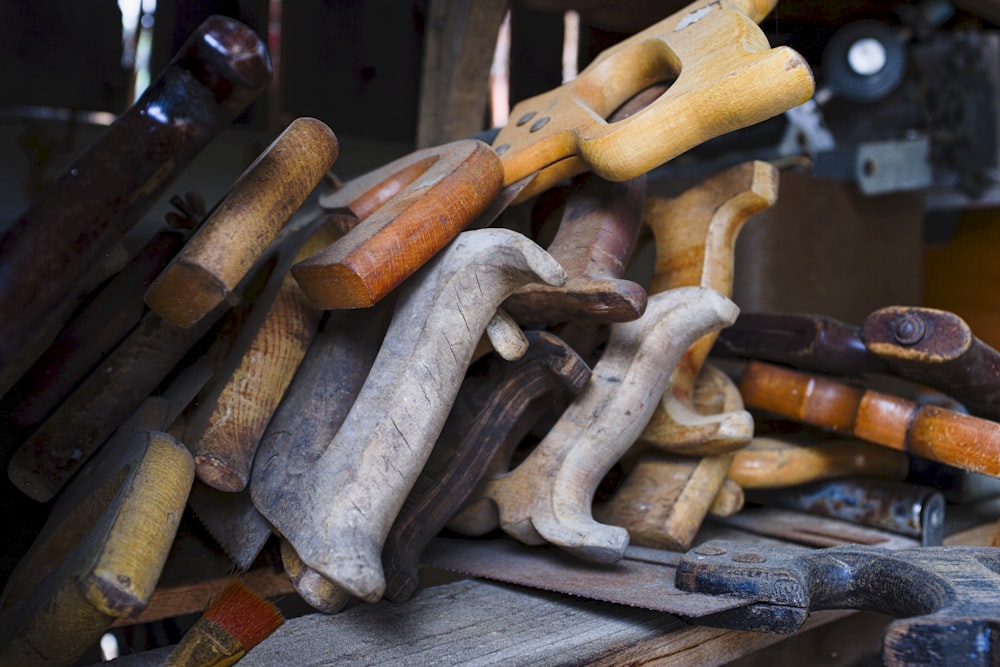 a pile of woodworking tools sitting on top of a table