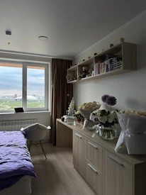 Cozy therapy room with calming purple and white decor, inviting and peaceful.