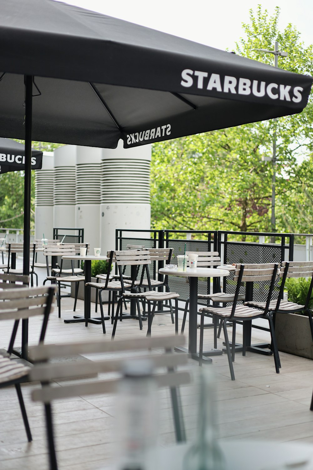 a restaurant with tables and chairs and an umbrella