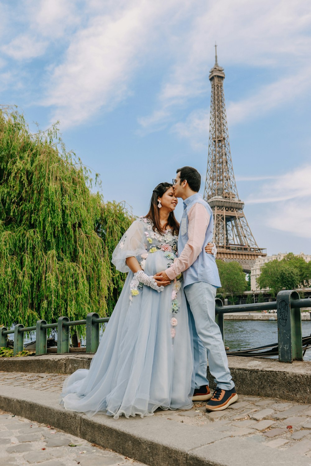 a man and a woman standing in front of the eiffel tower