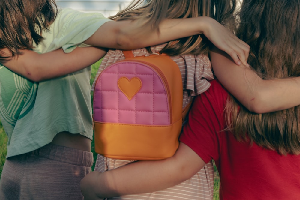 a group of young girls hugging each other