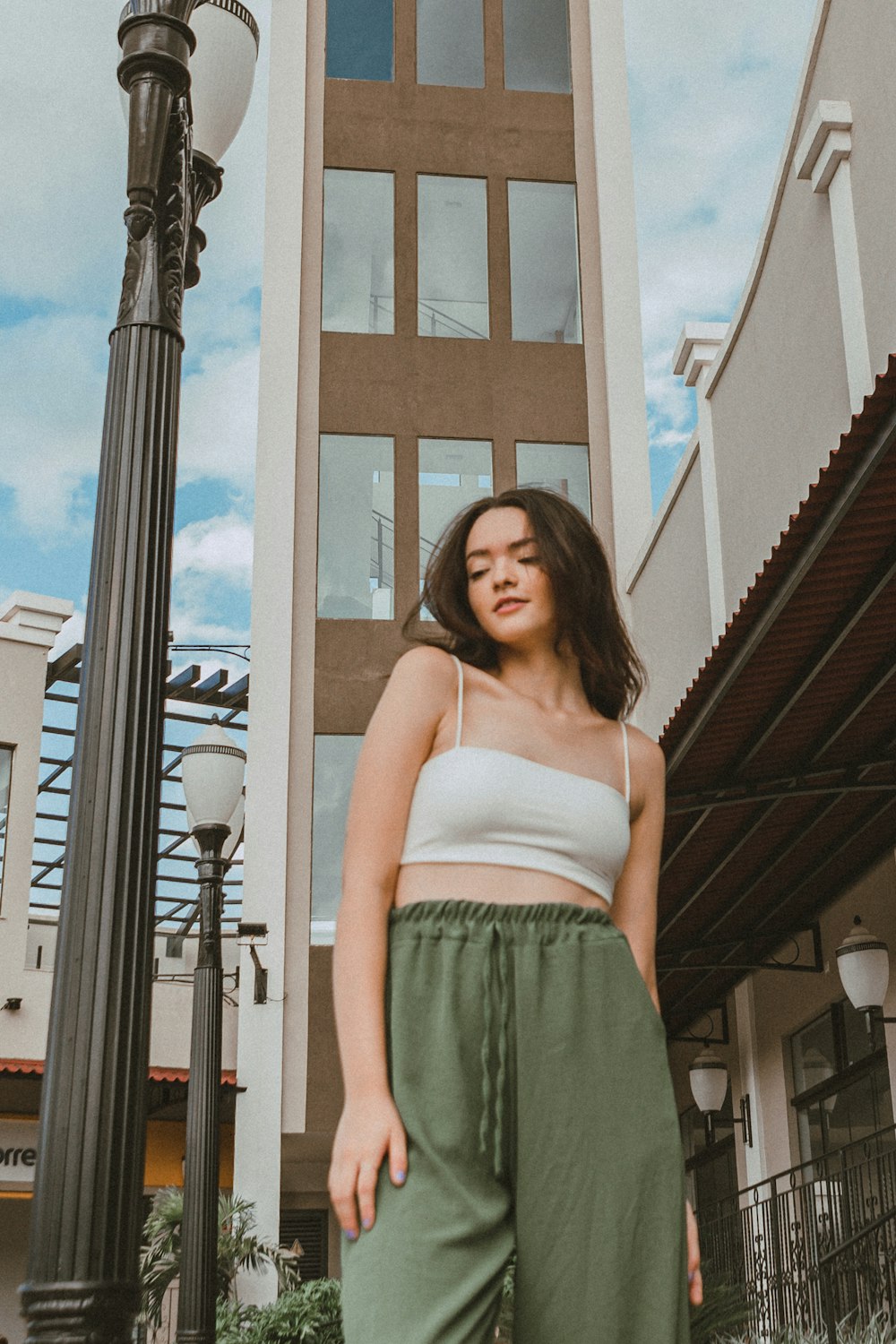 a woman standing in front of a tall building