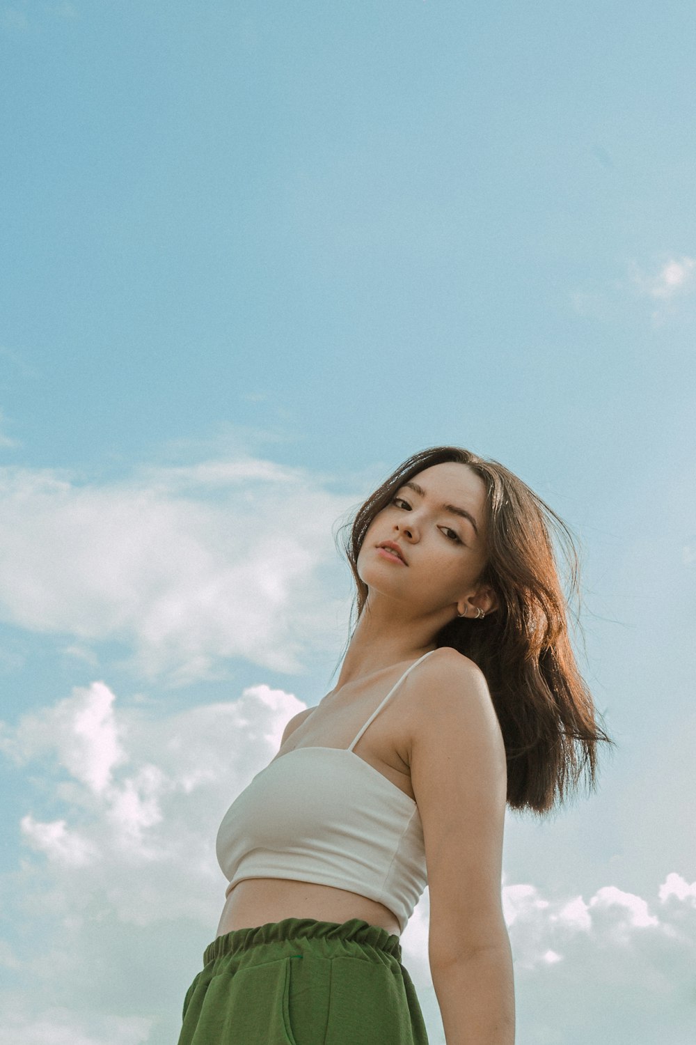 Une femme debout devant un ciel bleu