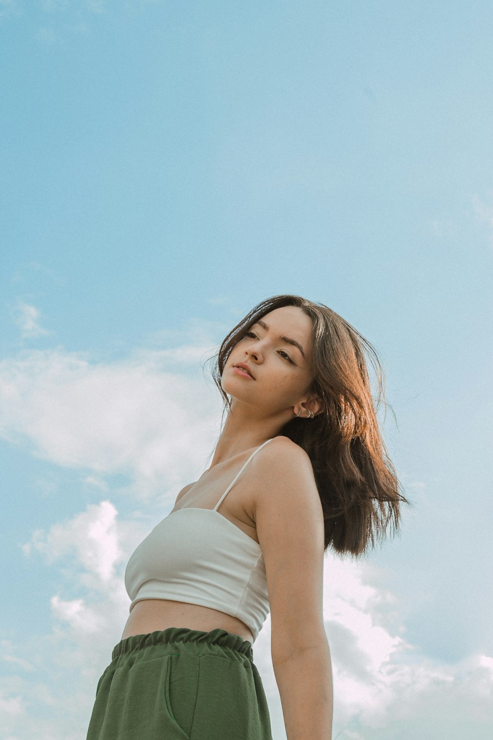 a woman standing in front of a blue sky