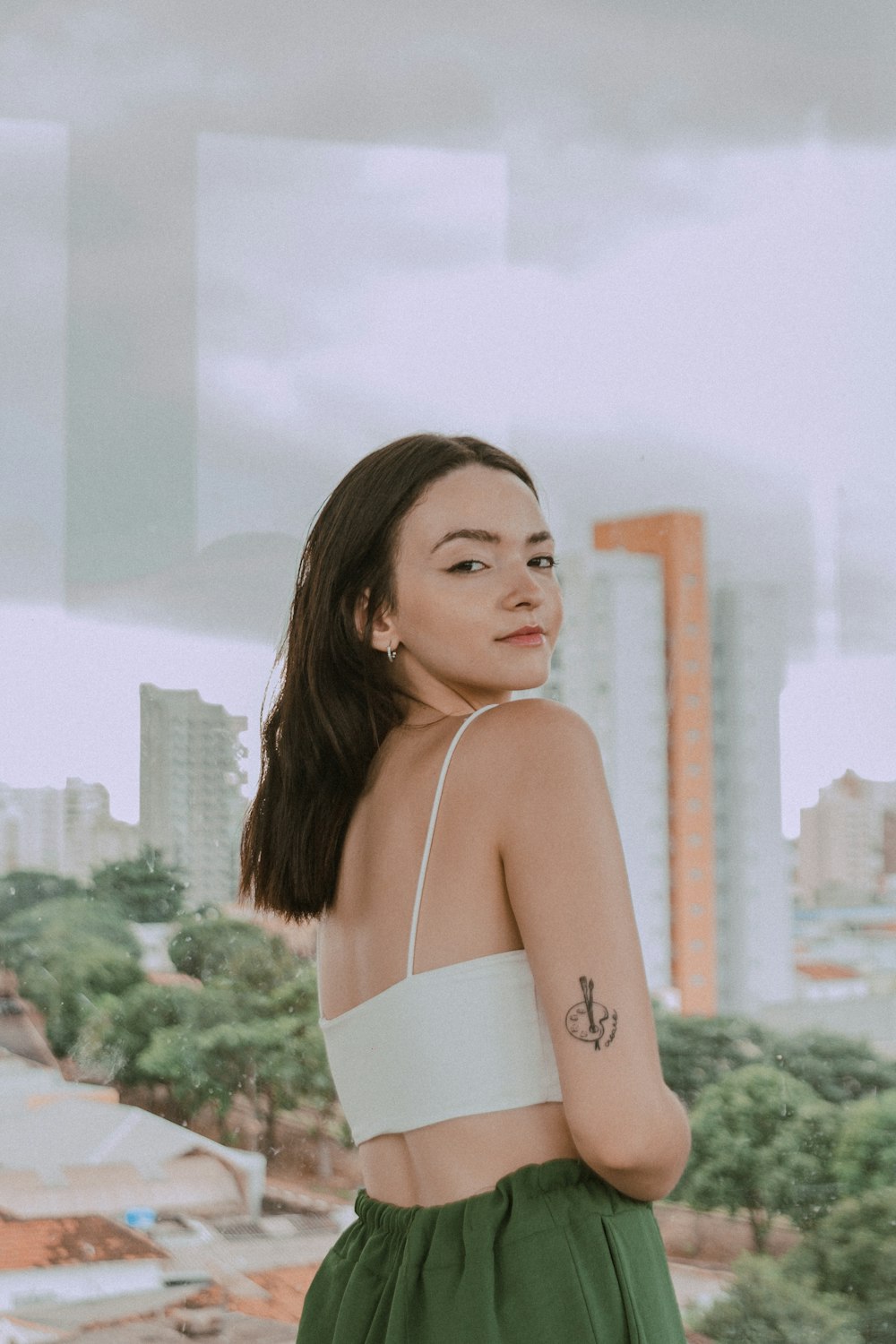 a woman in a white top and green skirt