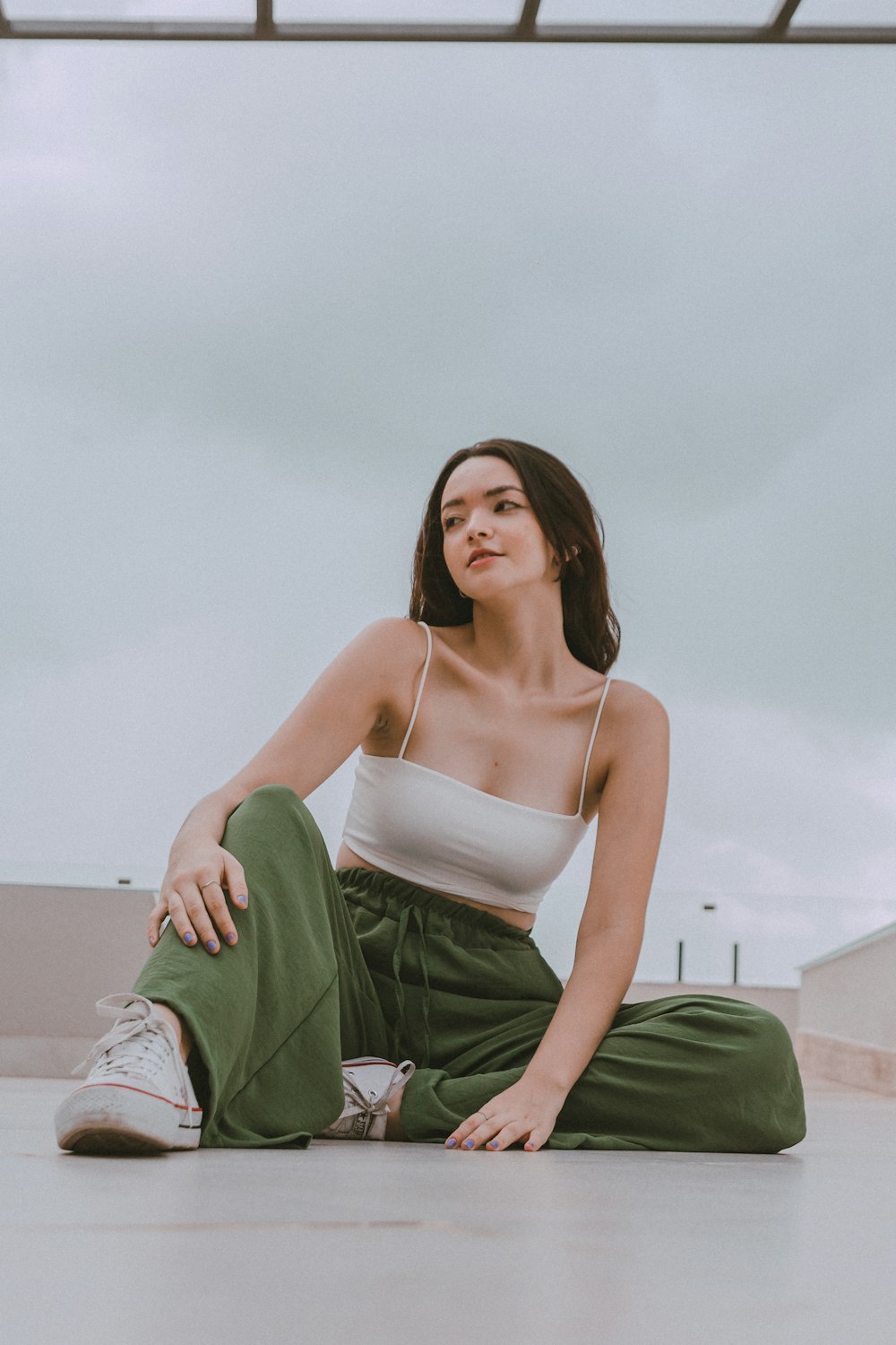 a woman sitting on the ground with her legs crossed