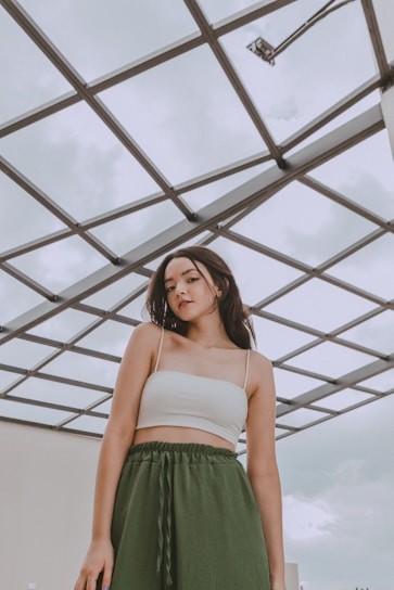 a woman in a white top and green skirt