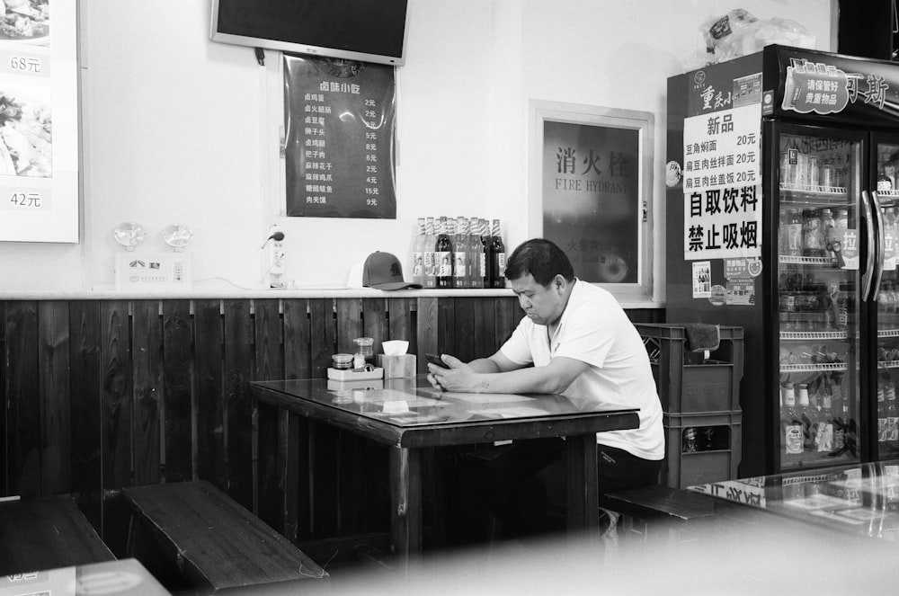 a man sitting at a table in a restaurant