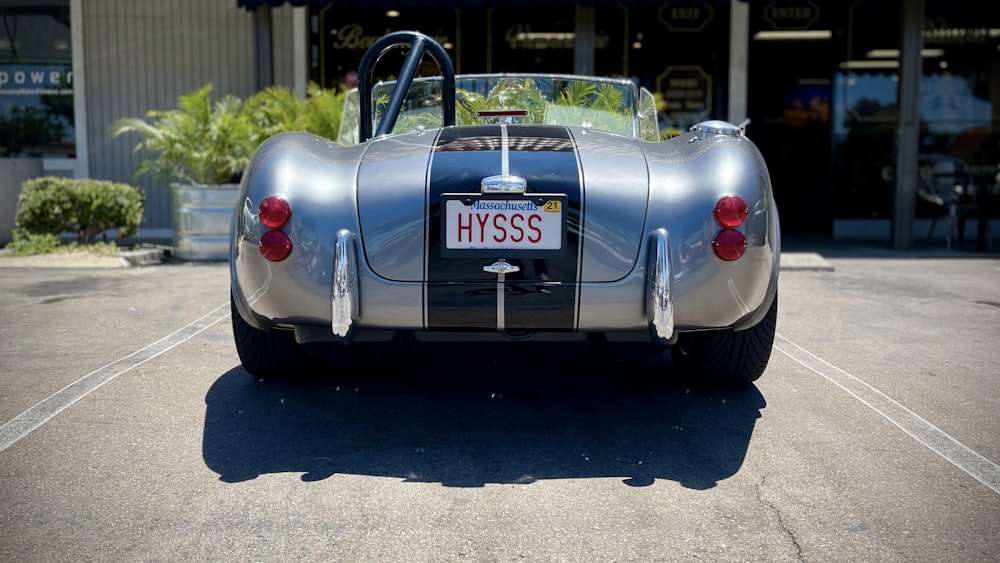 a silver and black car parked in a parking lot