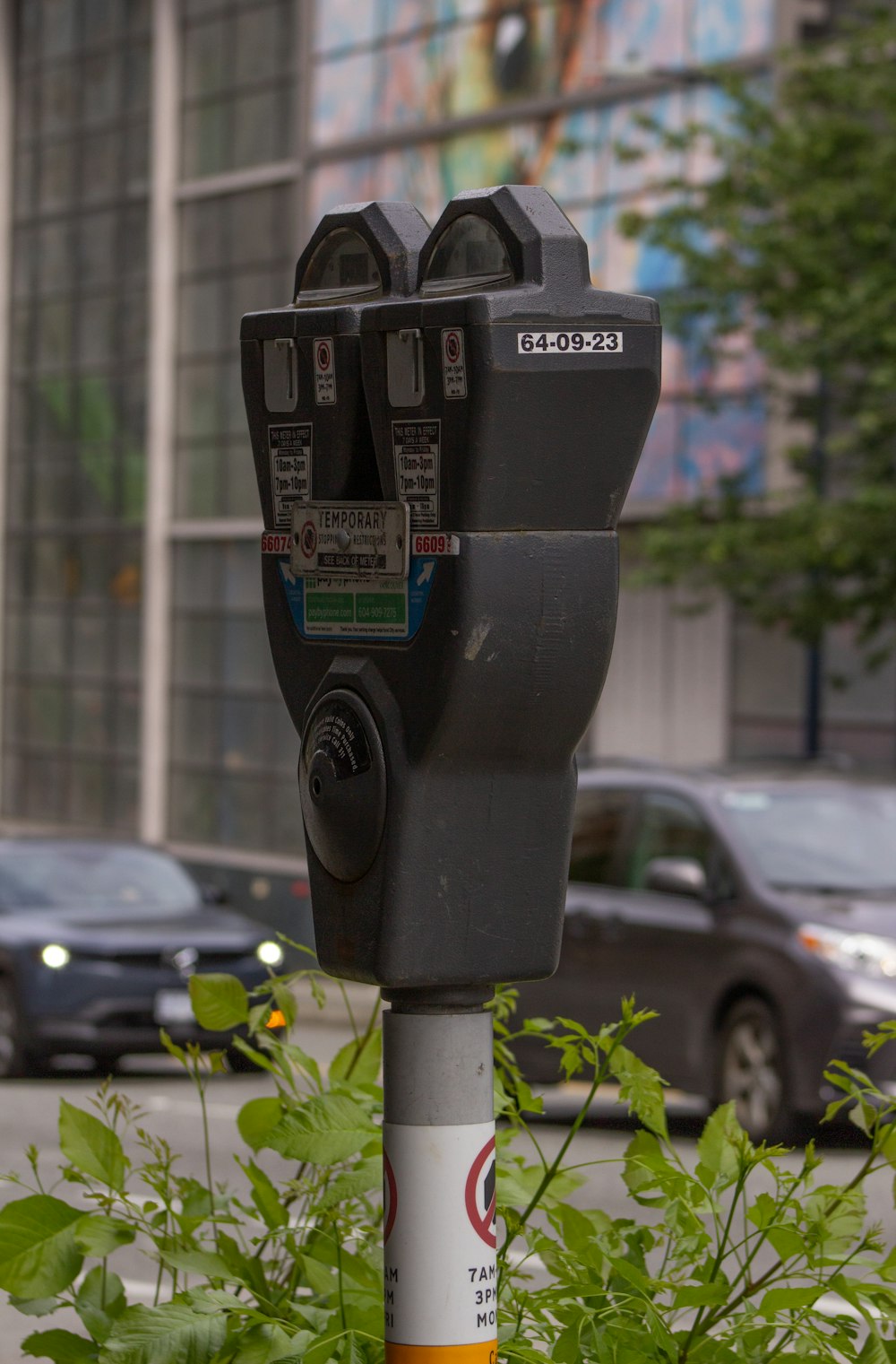 a parking meter sitting on the side of a road