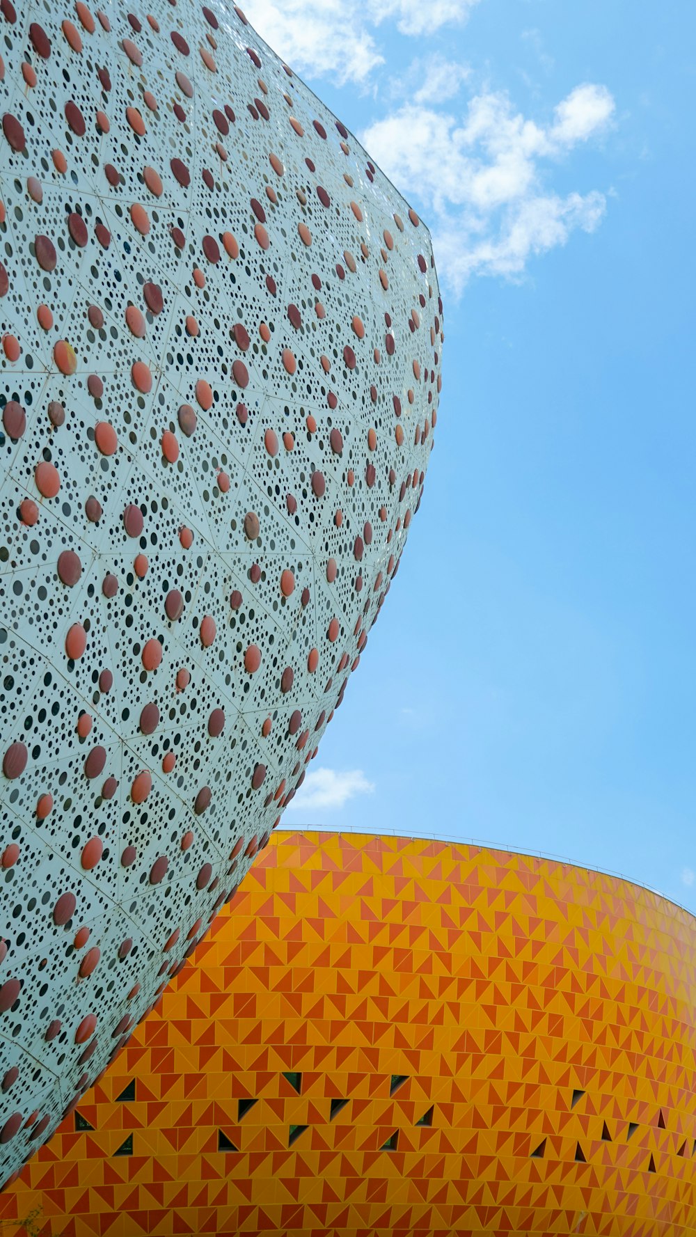 a close up of a building with a sky in the background