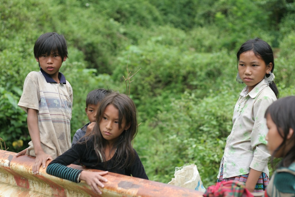 a group of young children standing next to each other