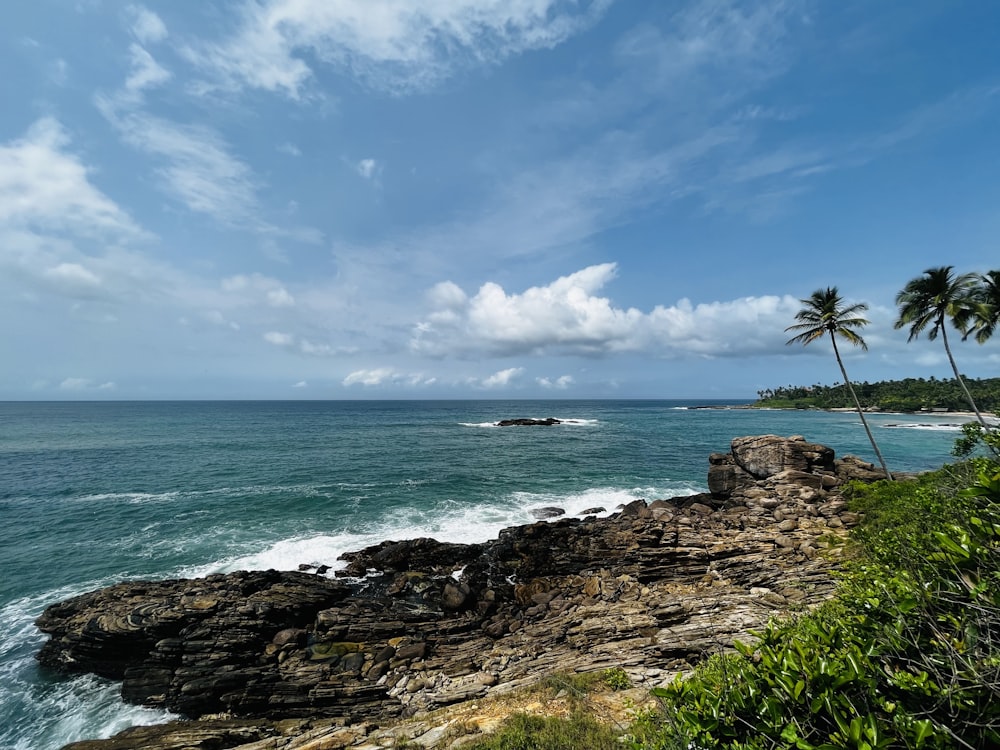 a view of the ocean from a rocky cliff