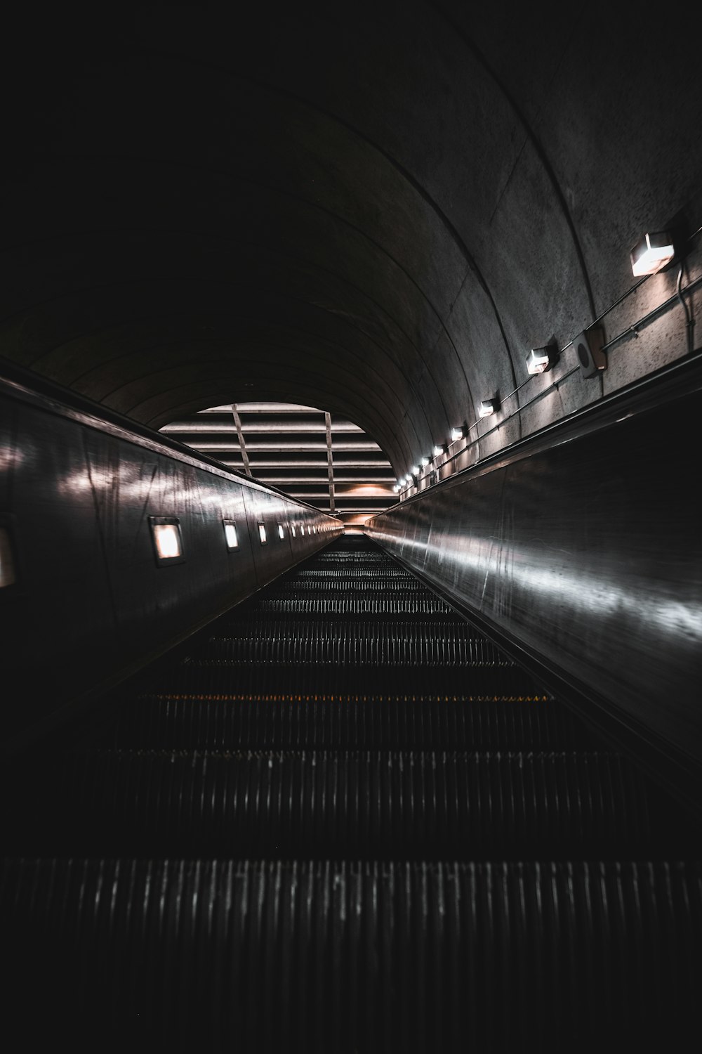 a train traveling through a tunnel next to a platform
