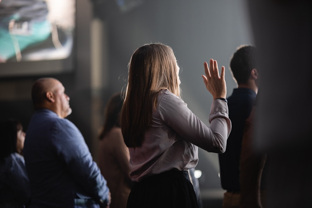 a woman standing in front of a crowd of people