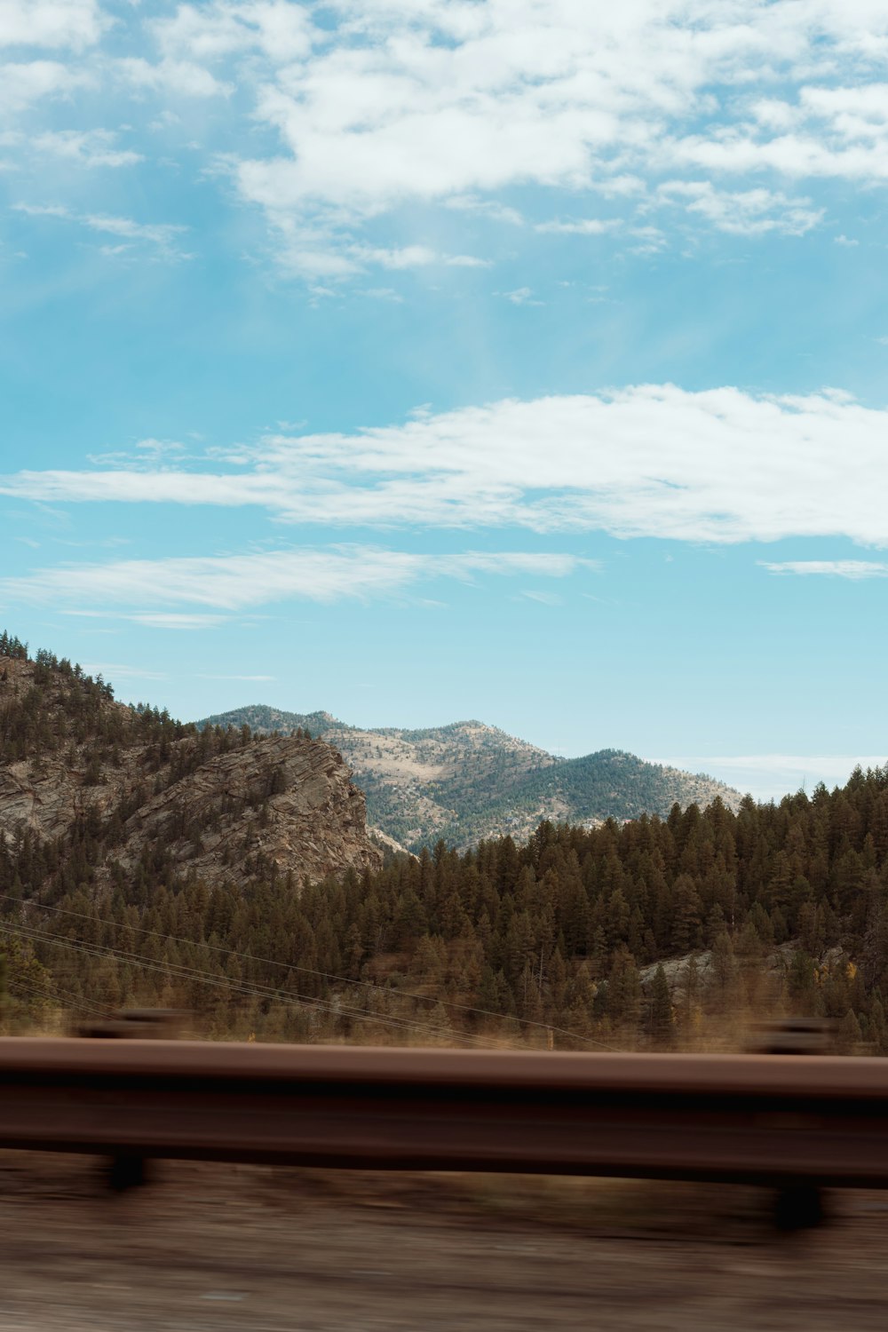 a view of a mountain range from a moving train