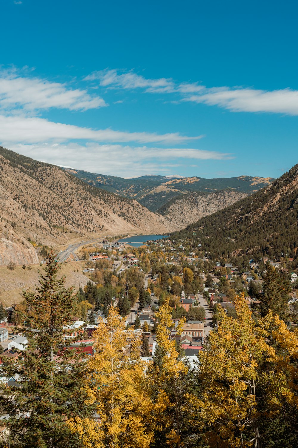 a scenic view of a town in the mountains