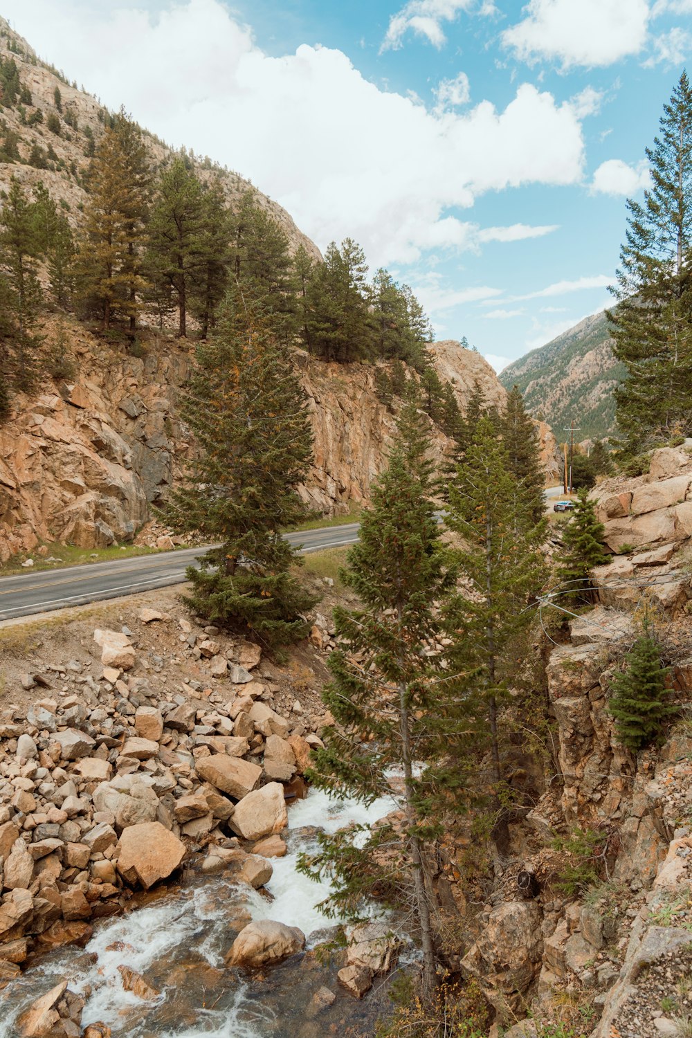 a river running through a rocky canyon next to a road