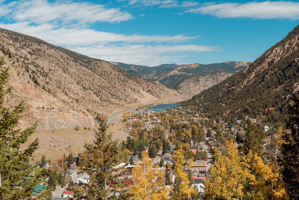 a scenic view of a town surrounded by mountains