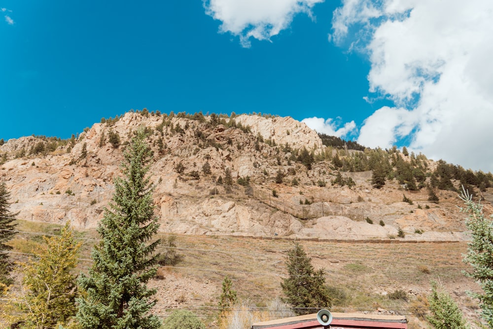 a mountain side with a stop sign in the foreground