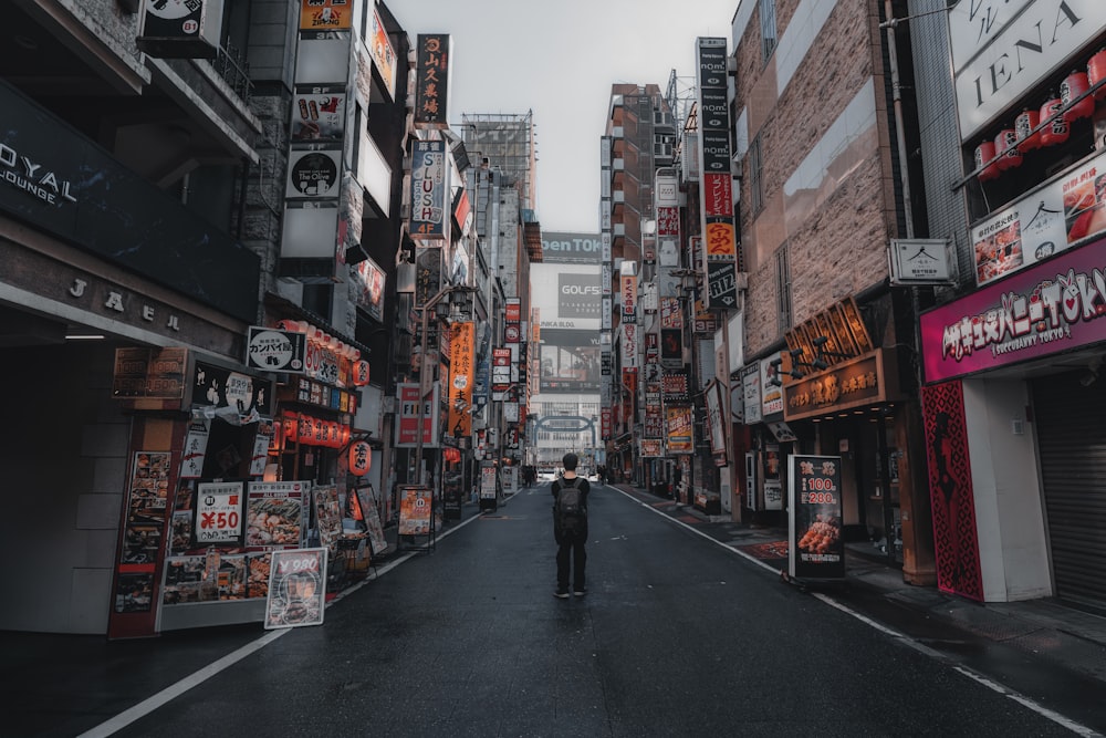 a man standing in the middle of a city street