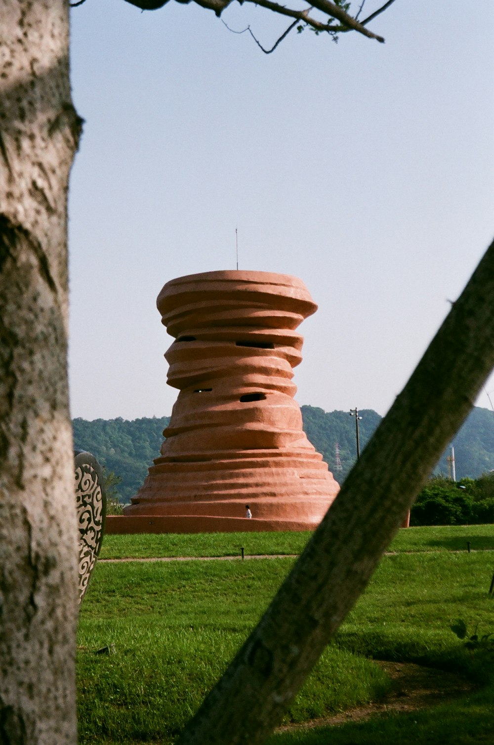 a large stone structure sitting in the middle of a lush green field