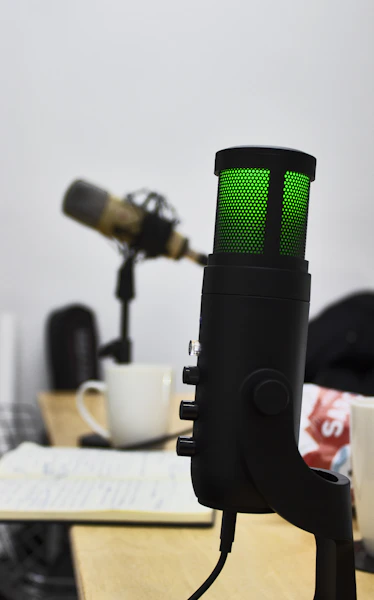 a microphone with a green light on top of it