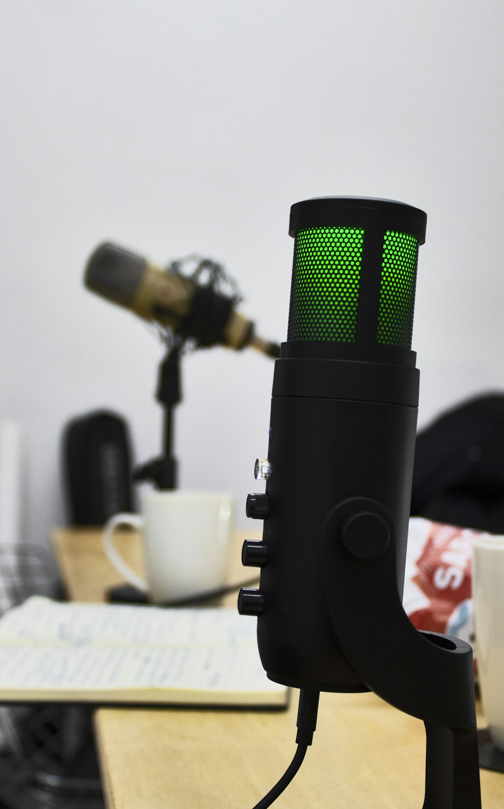 a microphone with a green light on top of it