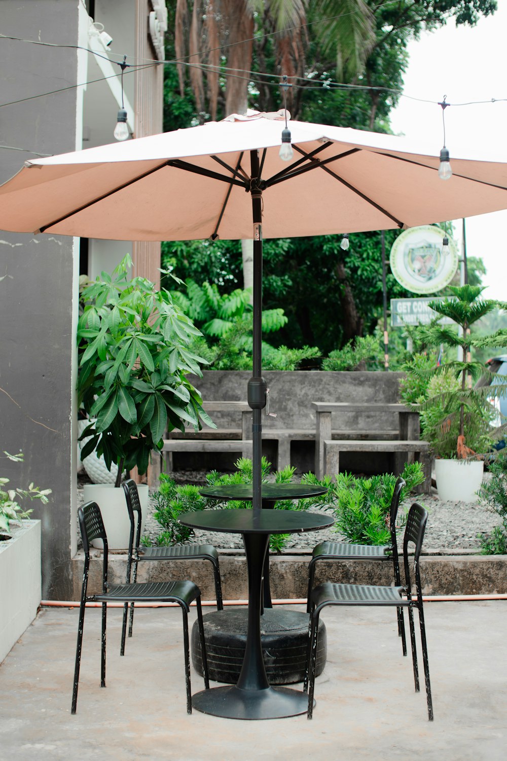 a table and chairs under an umbrella on a patio