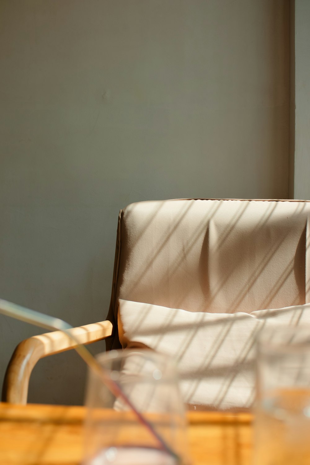 a wooden table with a chair and a glass on it