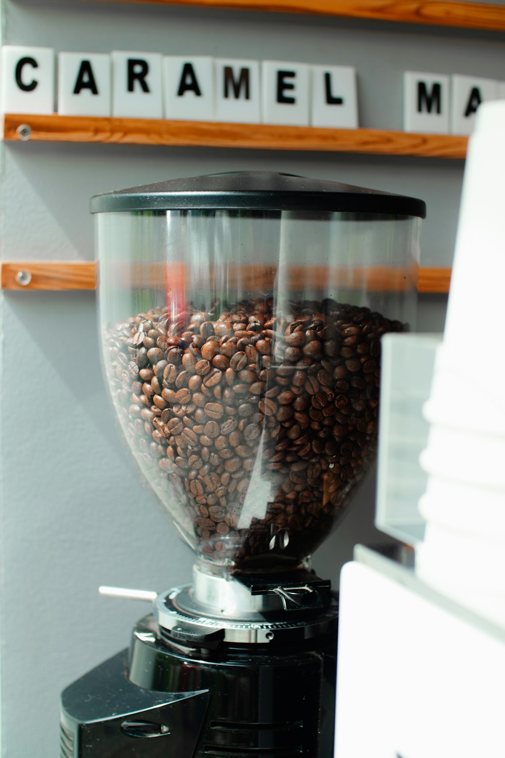 a coffee grinder filled with lots of coffee beans