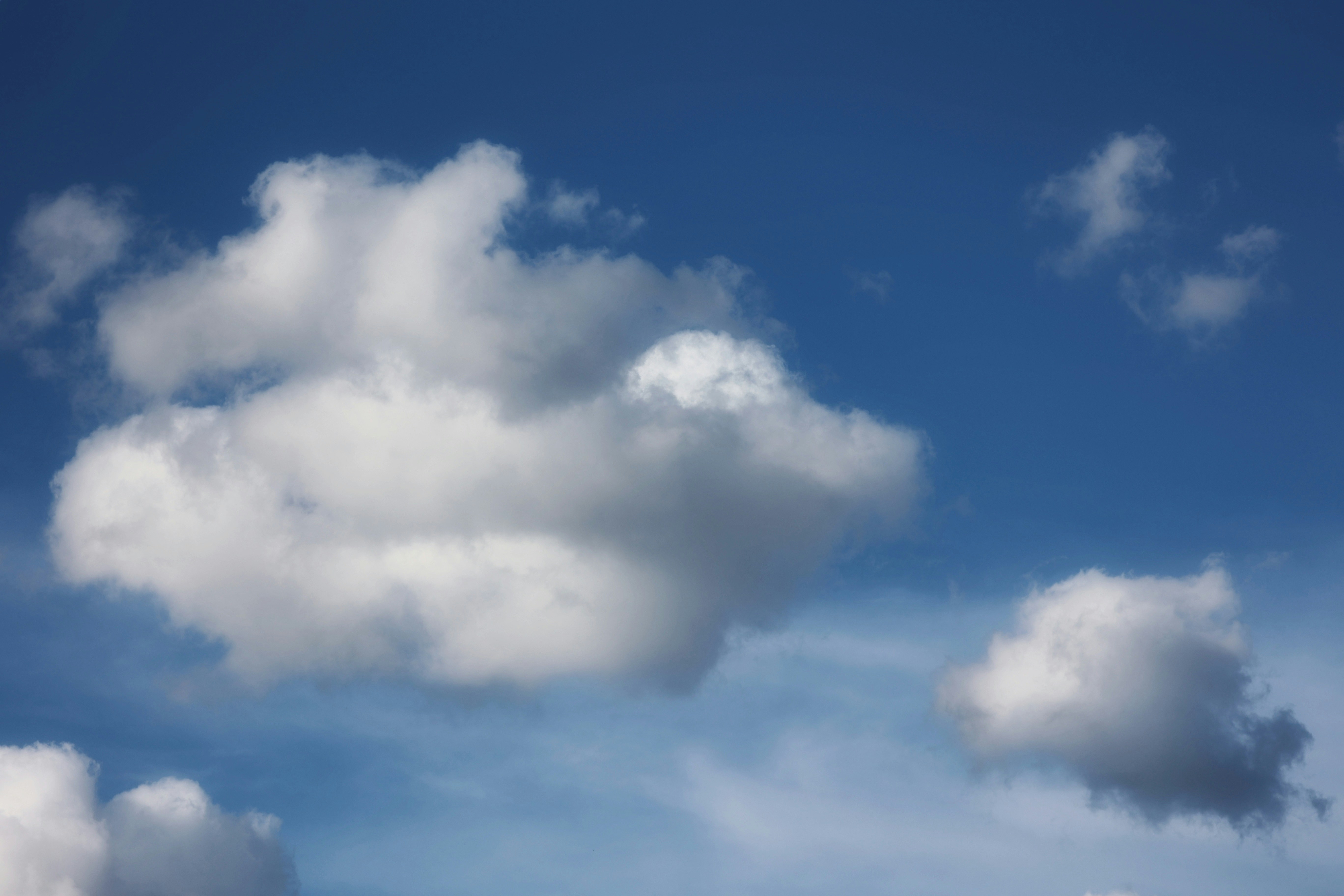 a group of white clouds in a blue sky