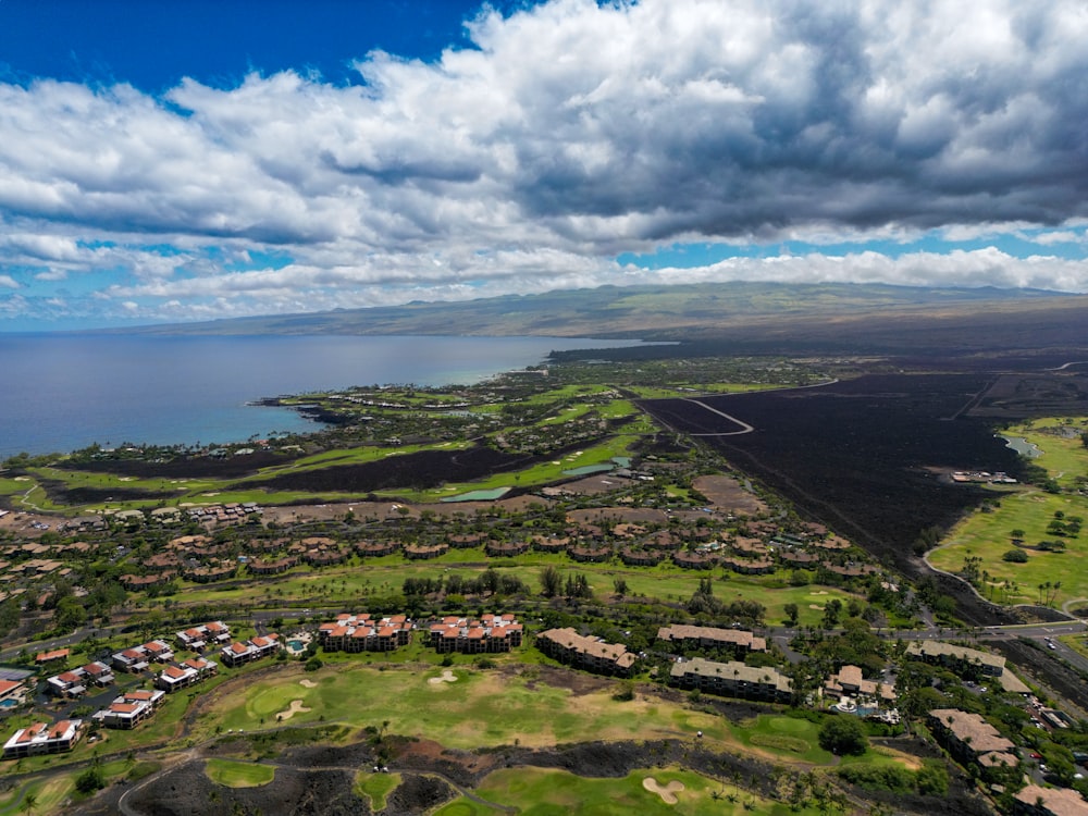 an aerial view of a golf course and the ocean