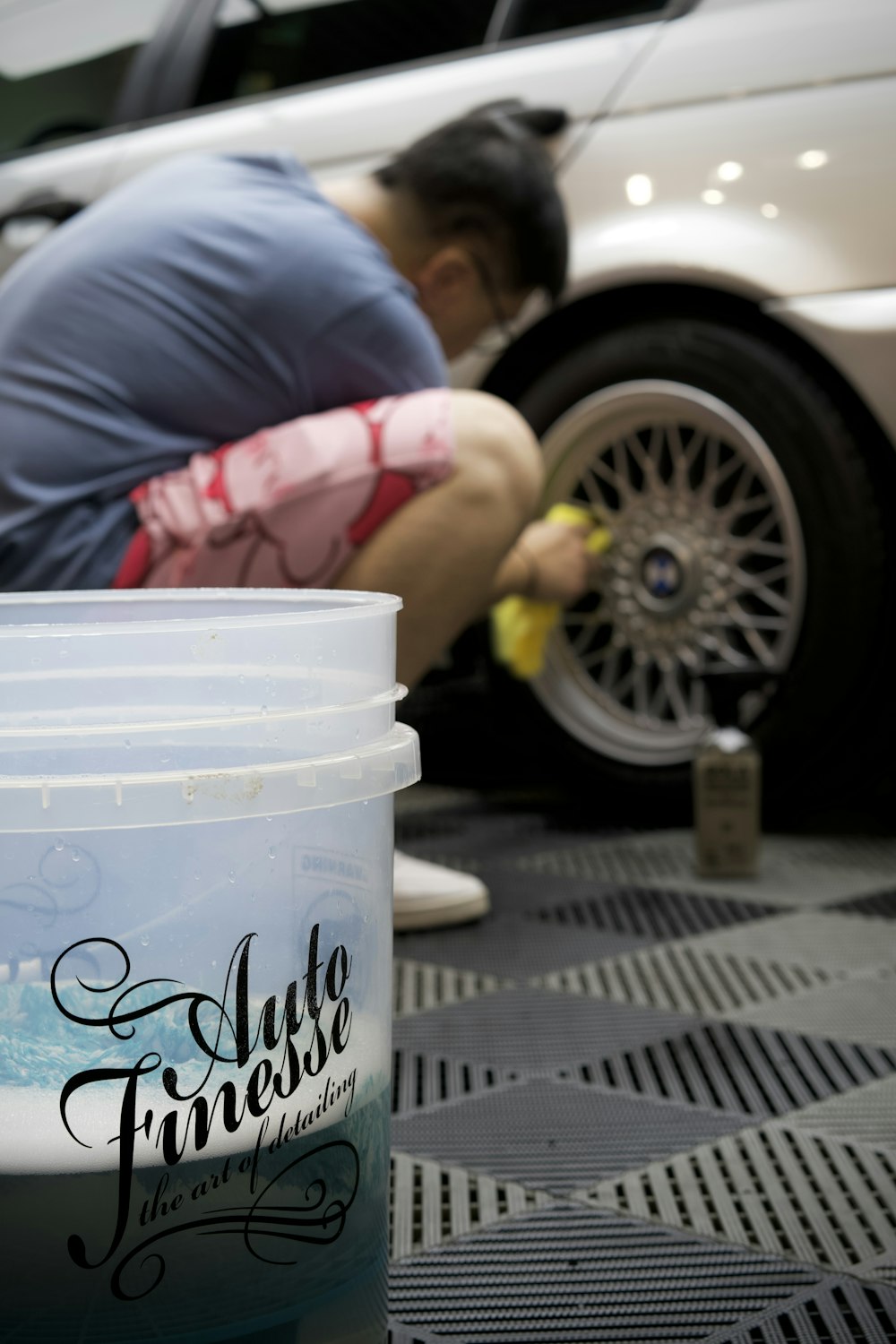 a man working on a tire on a car