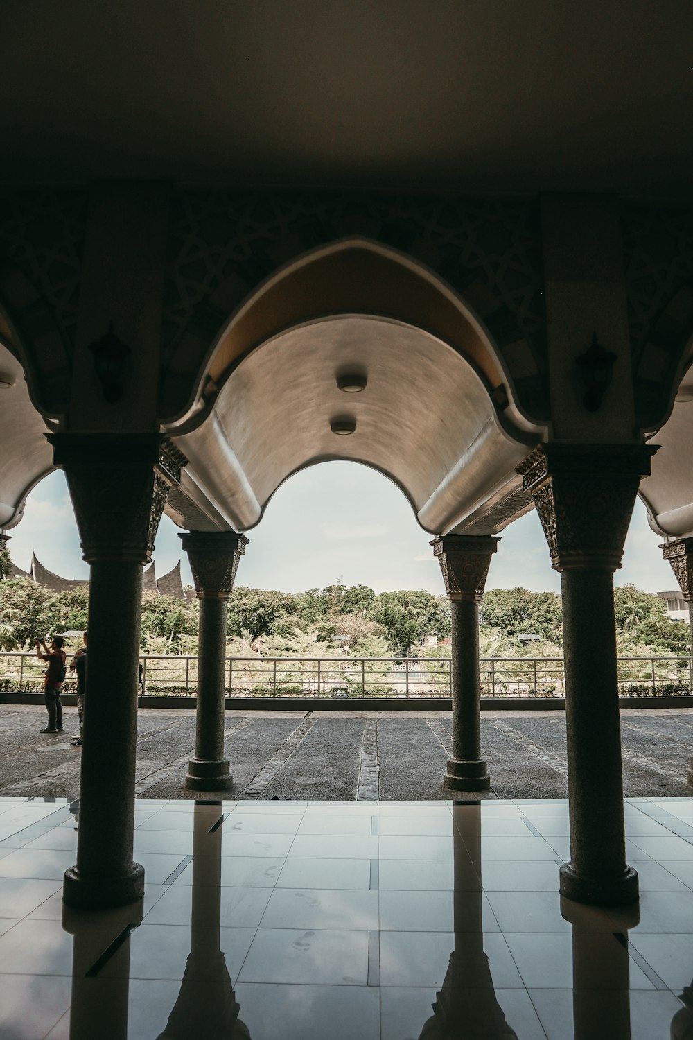 a group of pillars in a building with a sky background