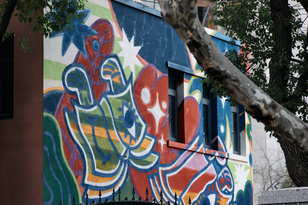 a colorful building with a tree in front of it