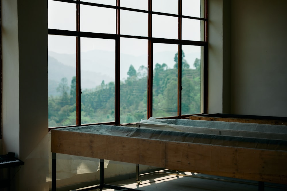 a bed sitting in front of a window in a room