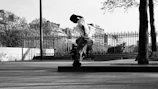 Advanced skater performing a controlled stop on an urban street route