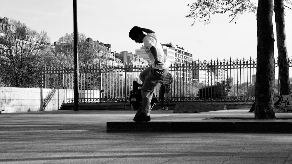 a man riding a skateboard down a sidewalk