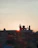 A serene sunset view of the Vishnupad Temple with pilgrims performing rituals by the Falgu River.