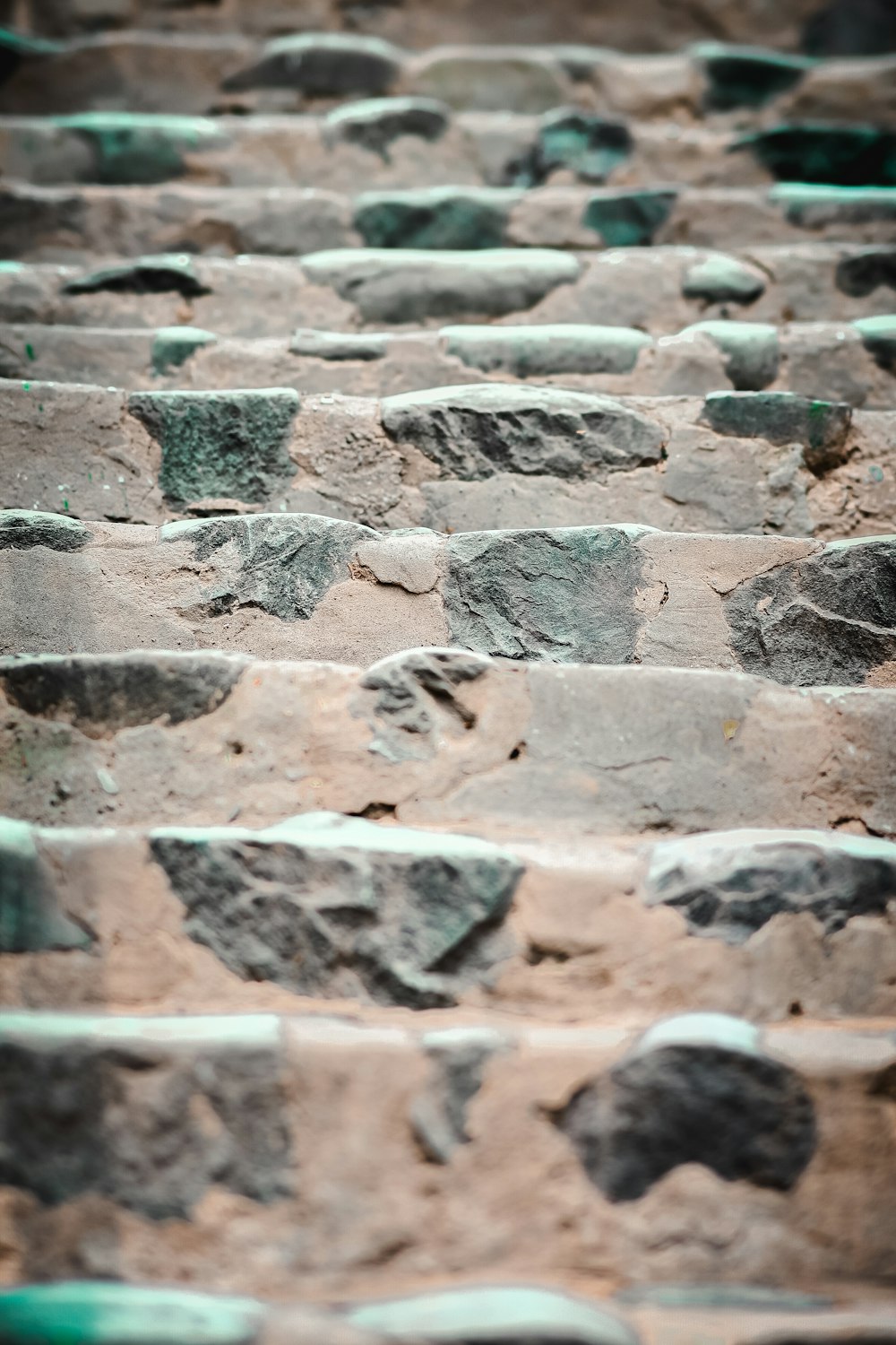 a close up of a brick wall with green paint