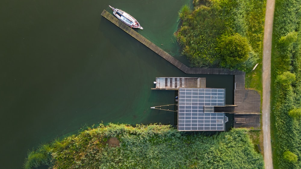 an aerial view of a dock with a boat in the water