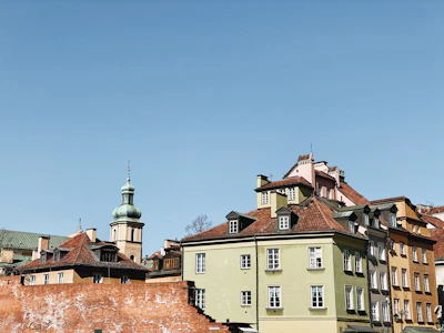 Historic architecture of Iași's old town under a bright blue sky.
