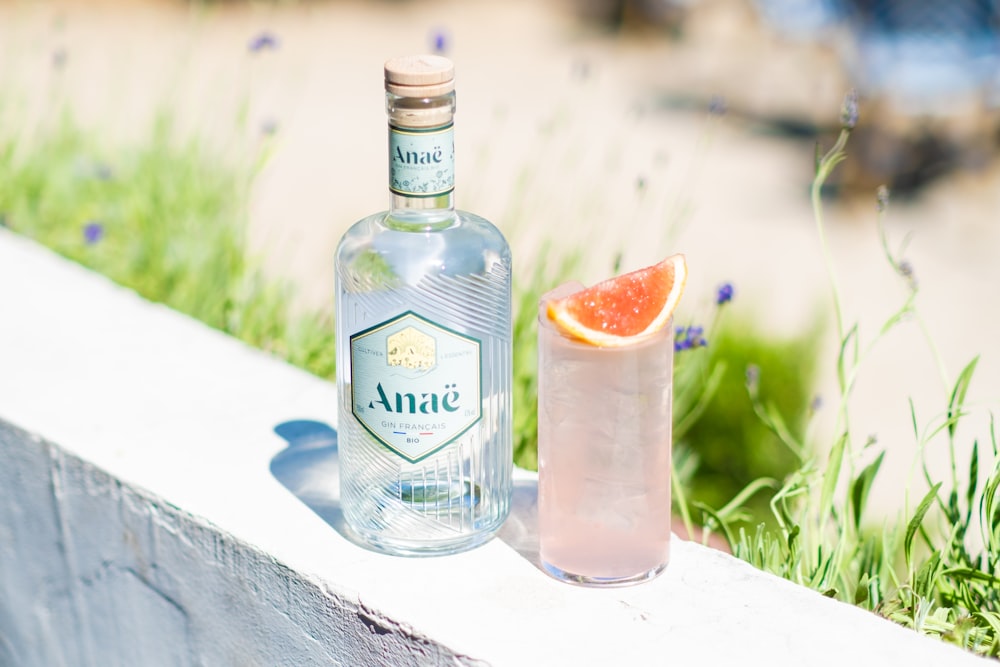 a bottle of alcohol sitting next to a glass