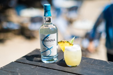 a bottle of vodka next to a glass of lemonade