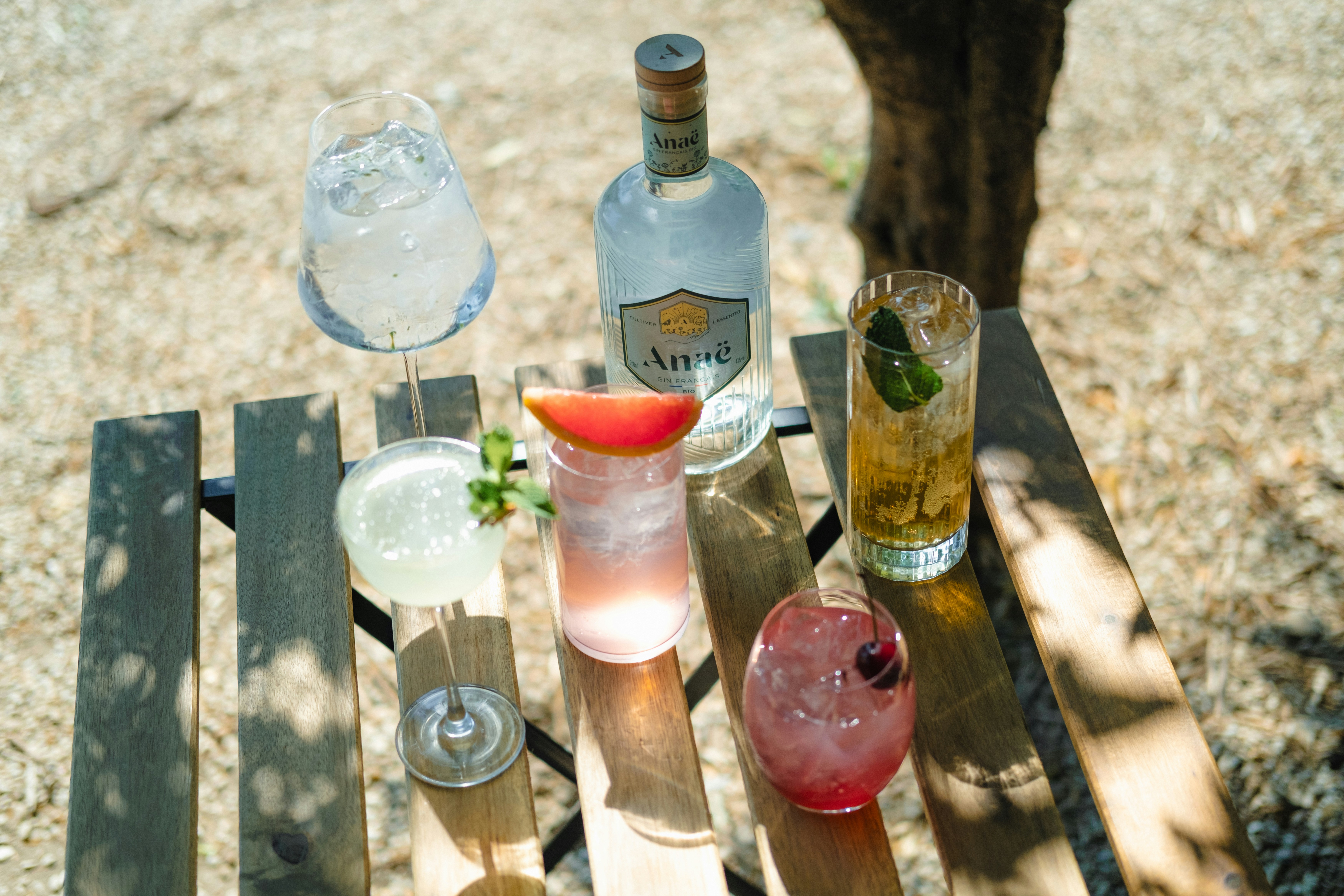 a wooden table topped with different types of drinks