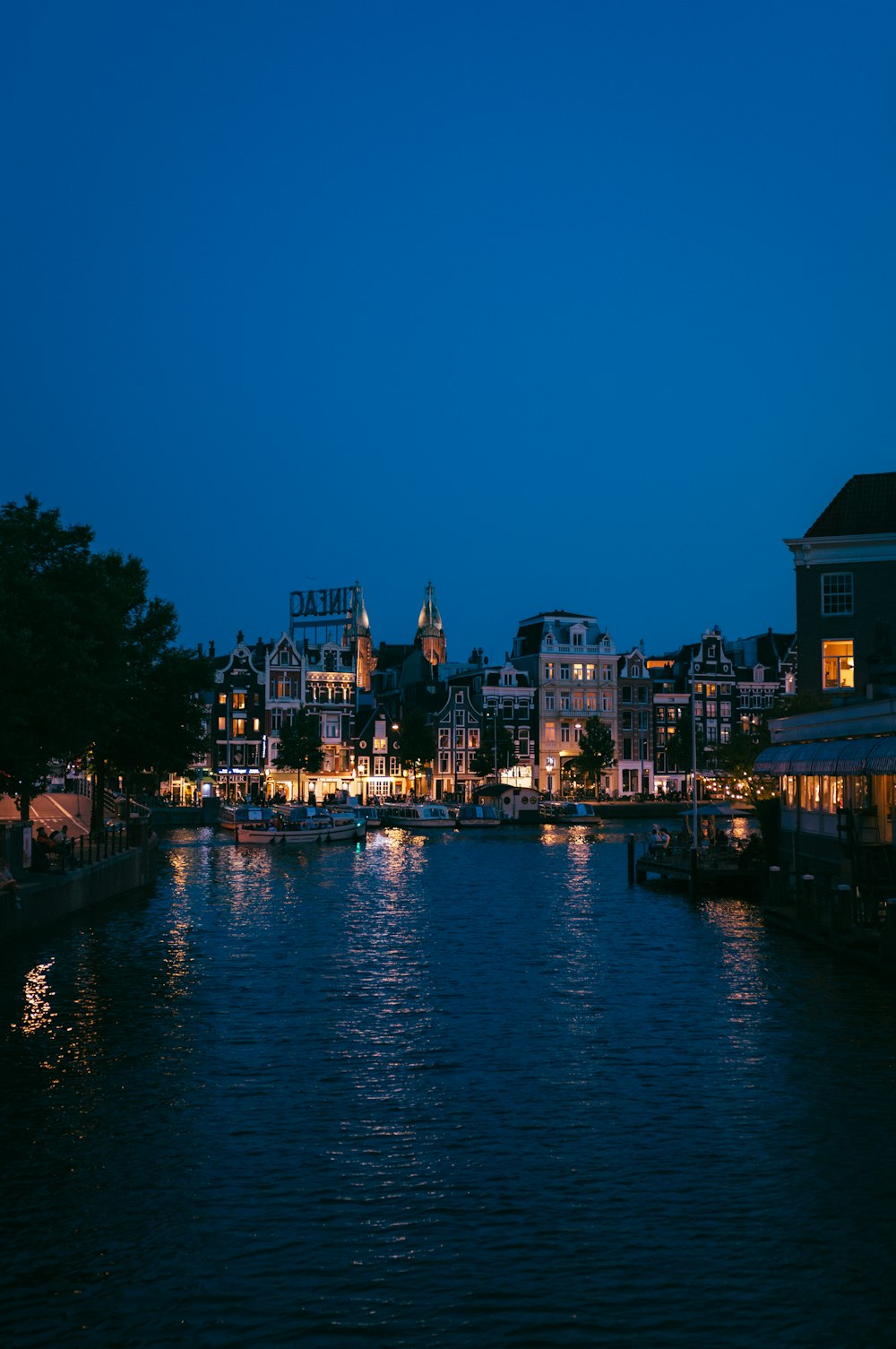 a body of water at night with buildings in the background